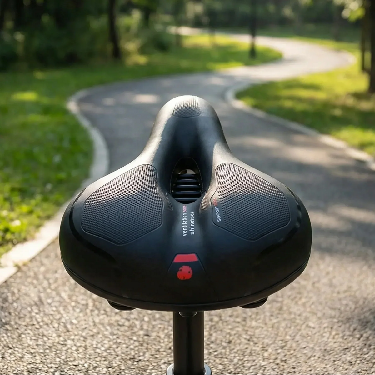 Wide bike saddle with pressure relief channel and ventilation zones