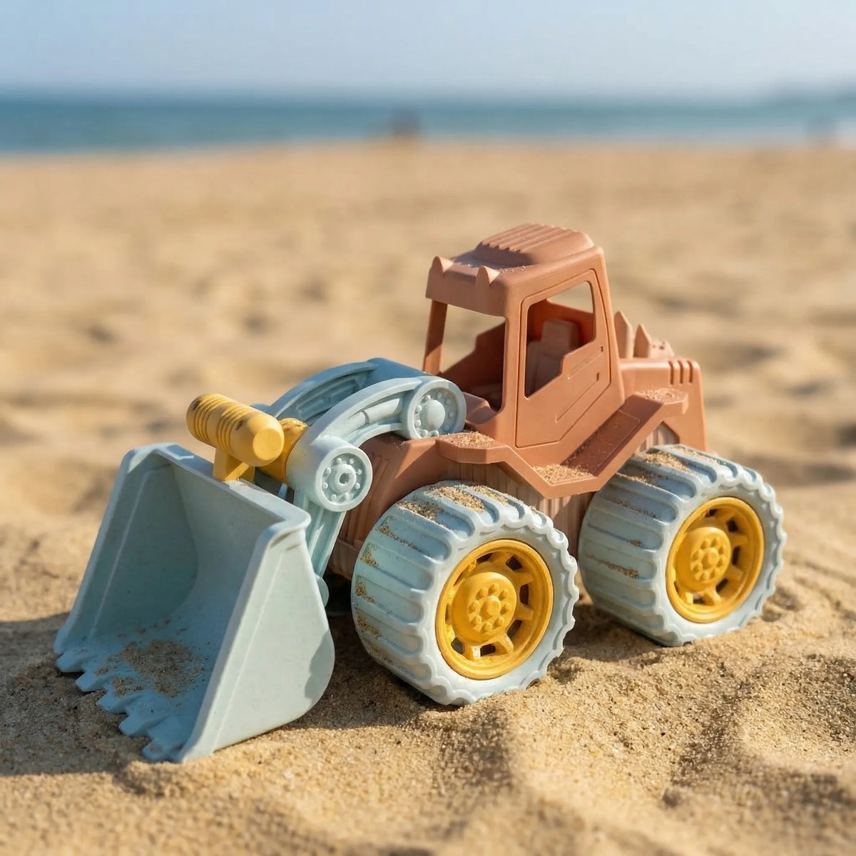 Kids sand digger toy with moving scoop for beach and sandpit play