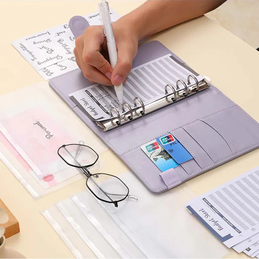 Compact ring binder organiser with cash envelope pockets and zip pouch