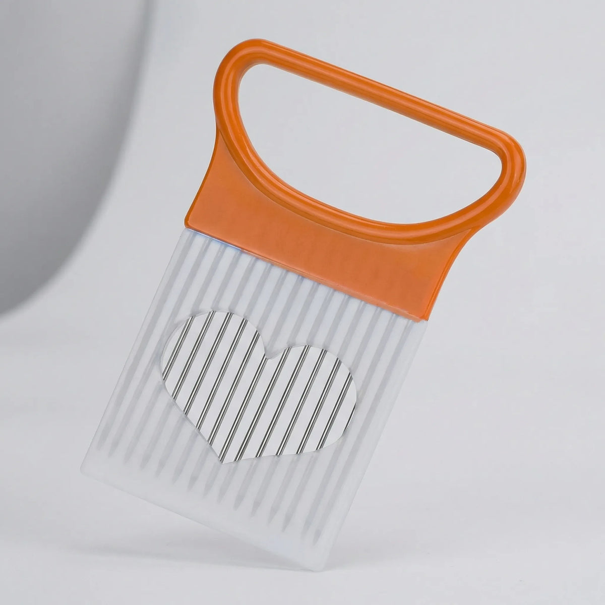 Hand-guided slicing guide with metal prongs for uniform vegetable cuts