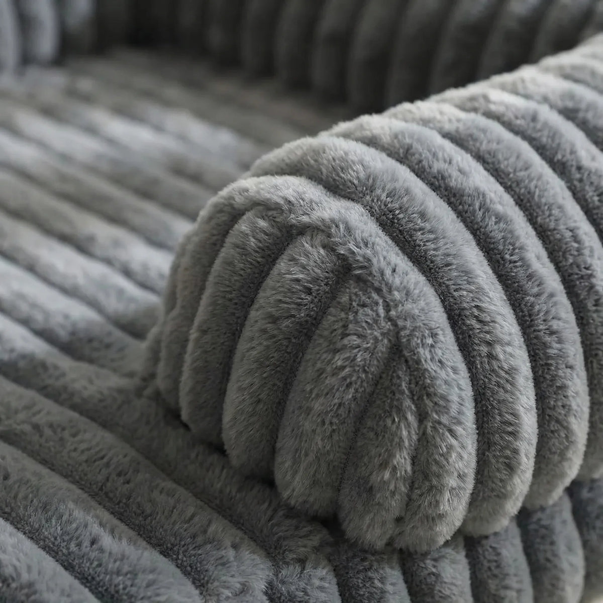 Sofa-style dog bed with raised sides and plush ribbed fabric cover