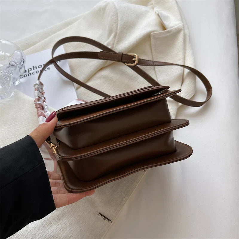 Small square shoulder bag with structured shape and smooth PU material