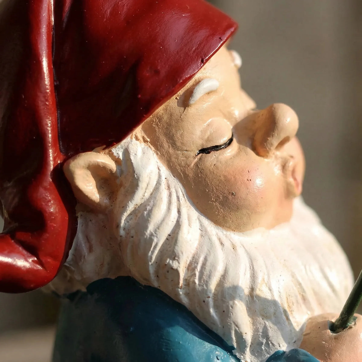 Hand-painted sleeping fishing gnome garden ornament with dangling fish