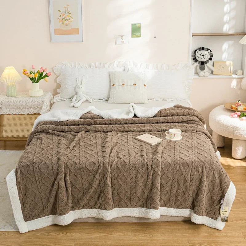 Reversible plush blanket with geometric knit pattern and sherpa lining