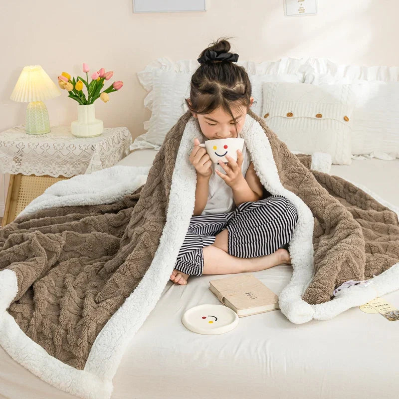 Reversible plush blanket with geometric knit pattern and sherpa lining