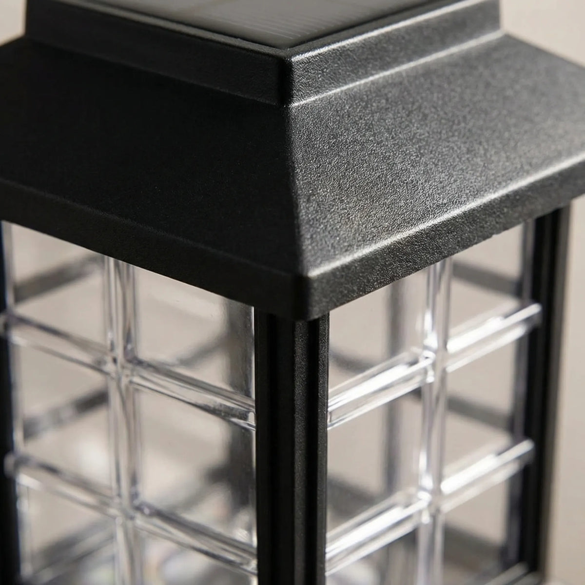 Solar-powered pathway lantern with warm amber glow and pagoda-style design