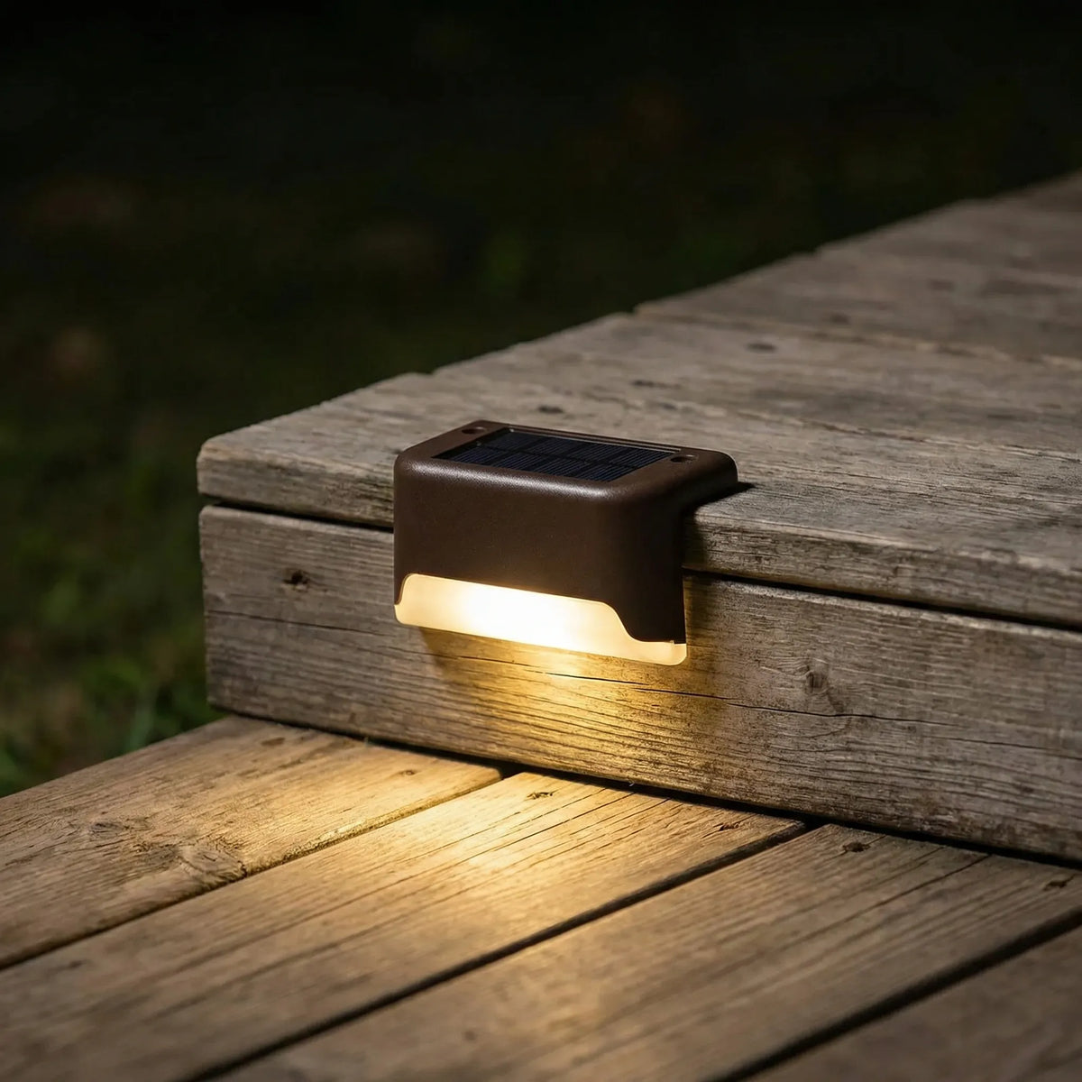 Solar step light with warm LED glow and clip-on mounting for decking