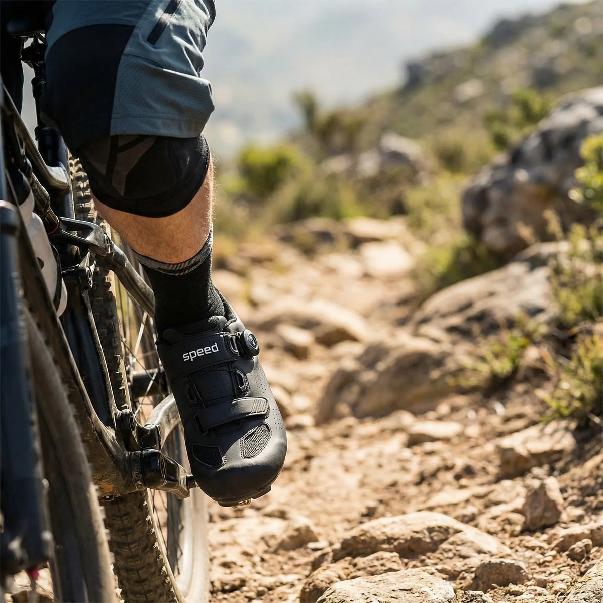 Mountain bike cycling shoe with self-locking cleat, rotary dial closure, and lugged sole