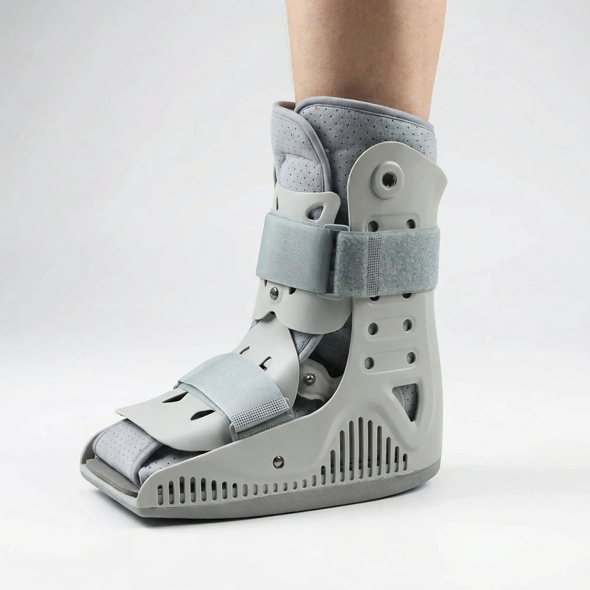 Inflatable orthopedic walking boot with air chambers and rocker sole