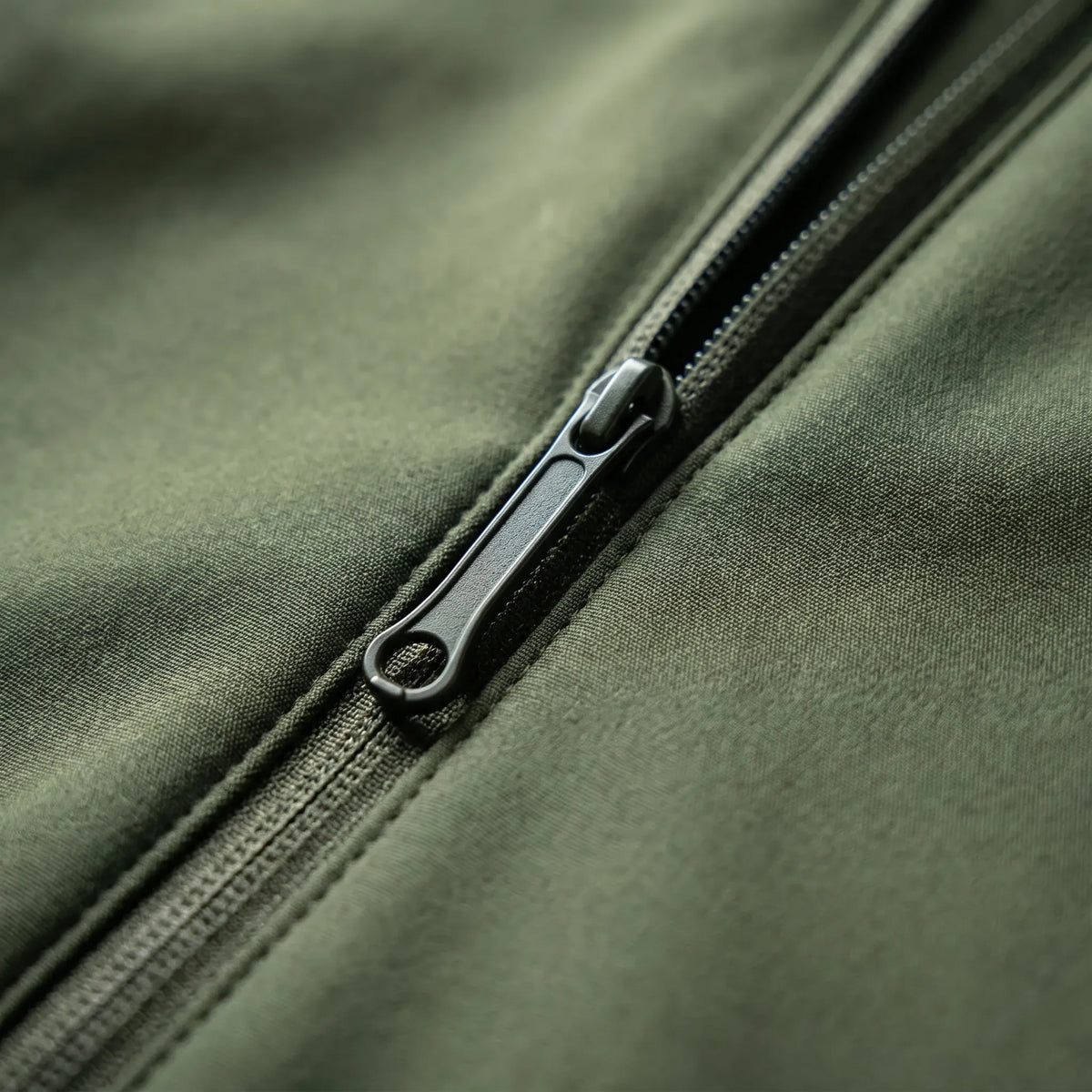 Tactical soft shell jacket with wind-resistant fabric and adjustable hood