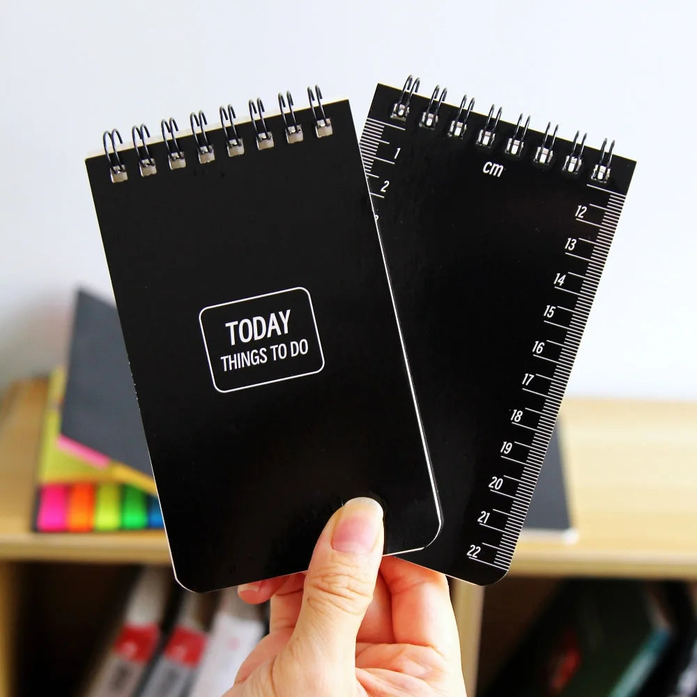 Compact A7 pocket notepad with top spiral binding and lined pages