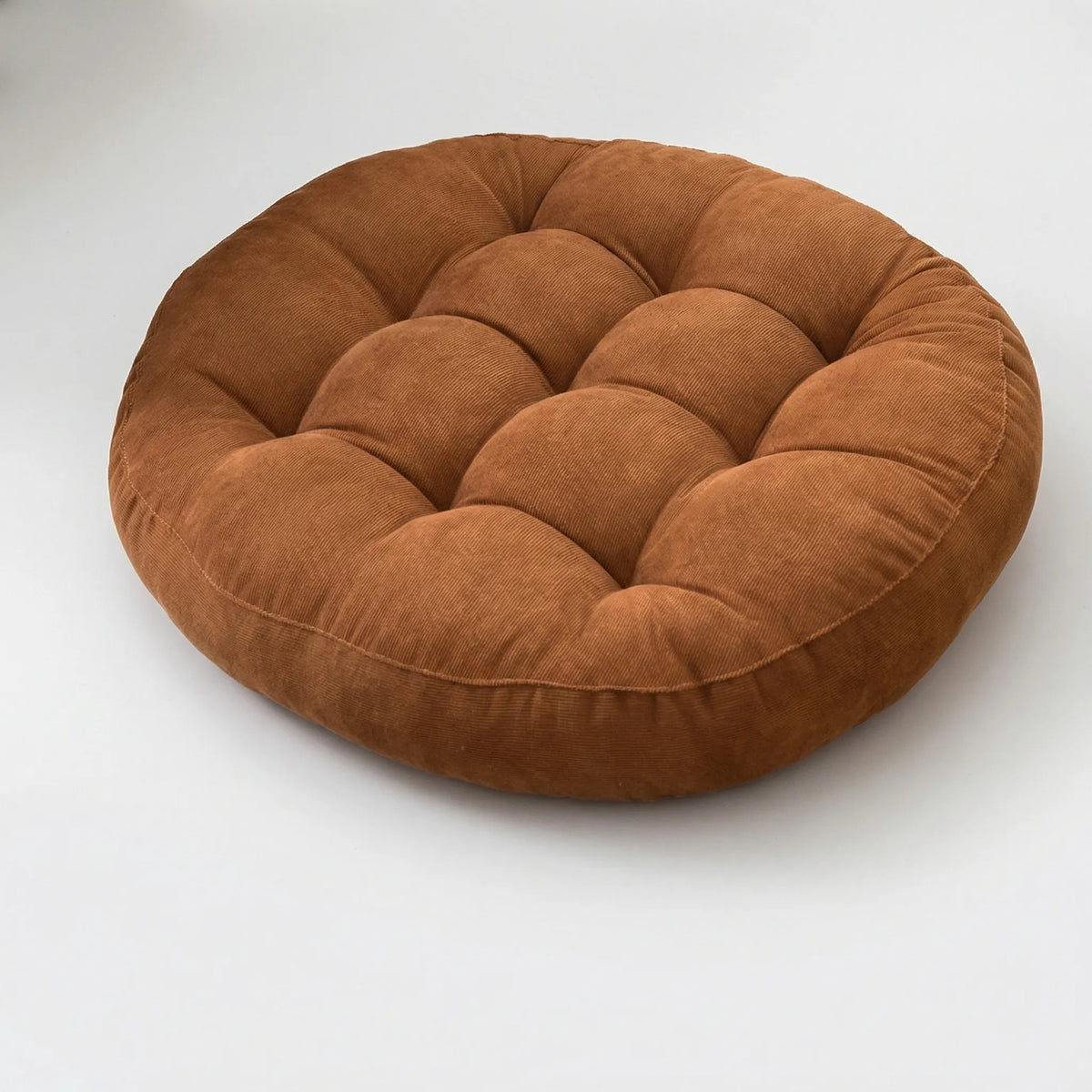 Large round quilted floor cushion with textured corduroy surface