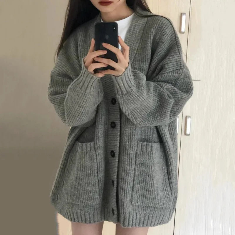 Oversized knit cardigan with deep V-neck and patch pockets for women
