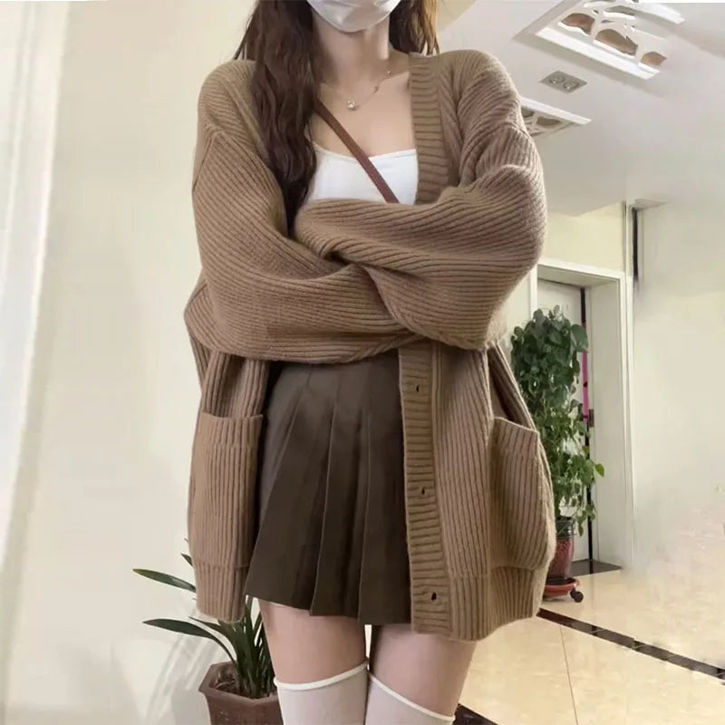 Oversized knit cardigan with deep V-neck and patch pockets for women