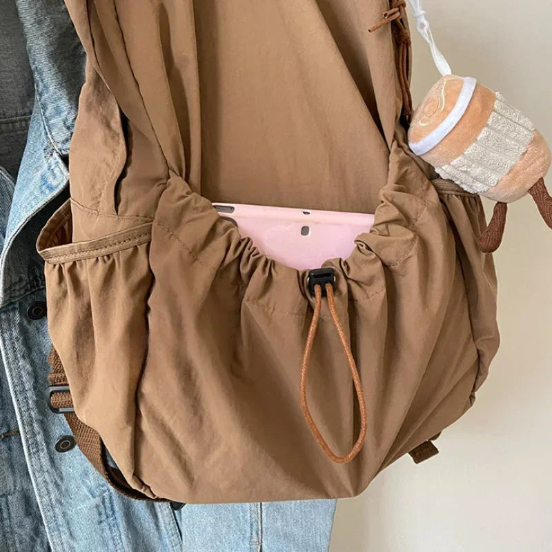 Large-volume nylon backpack with pleated design and padded straps