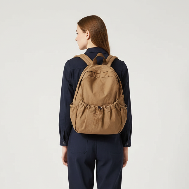 Large-volume nylon backpack with pleated design and padded straps