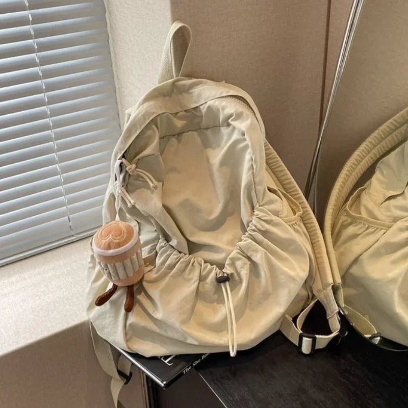 Large-volume nylon backpack with pleated design and padded straps