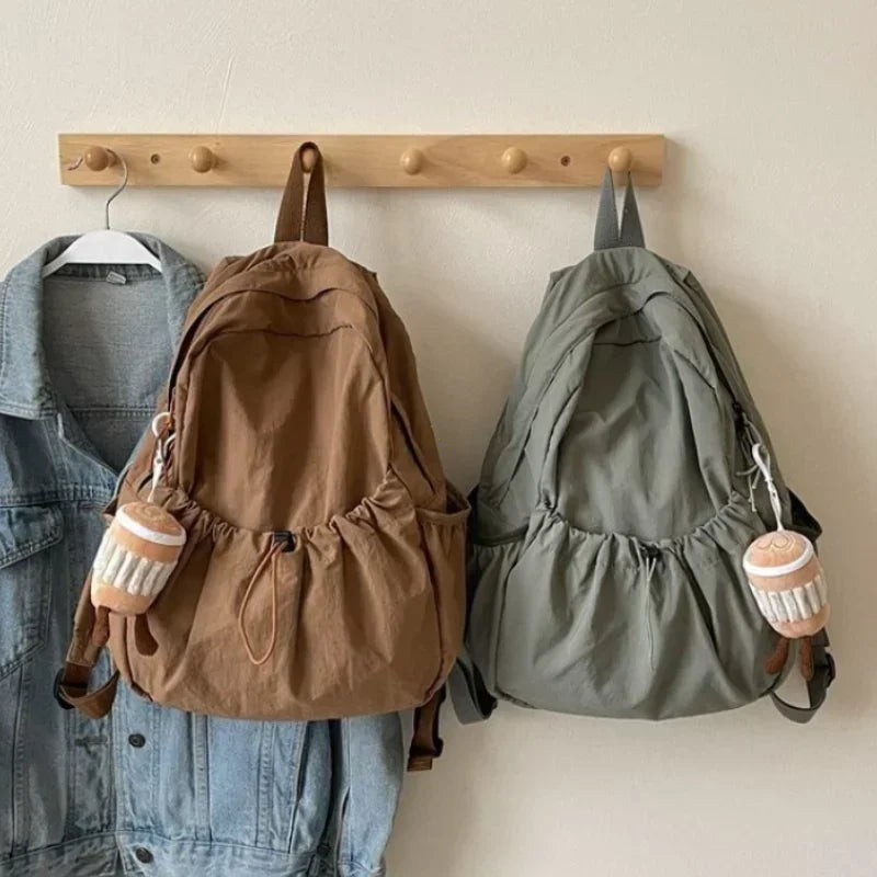 Large-volume nylon backpack with pleated design and padded straps