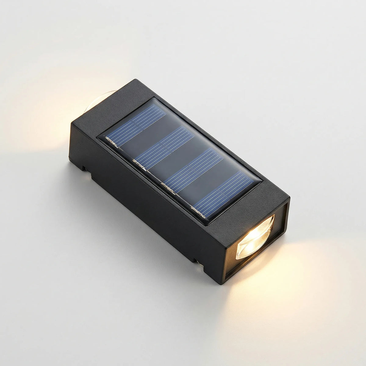 Solar-powered outdoor wall light with up-down LED glow