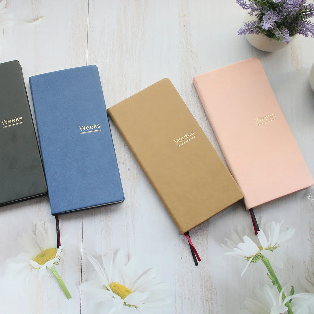 Slim weekly planner notebook with ribbon markers and protective cover