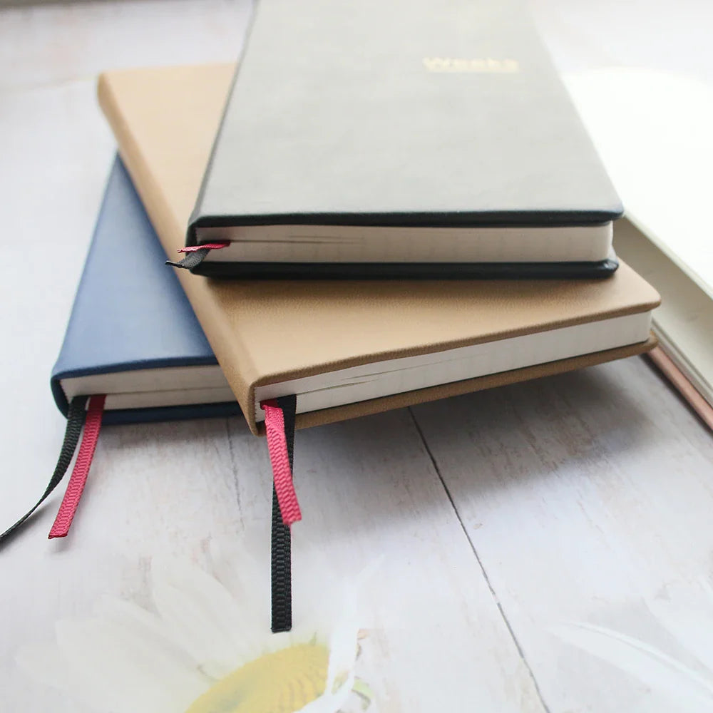 Slim weekly planner notebook with ribbon markers and protective cover