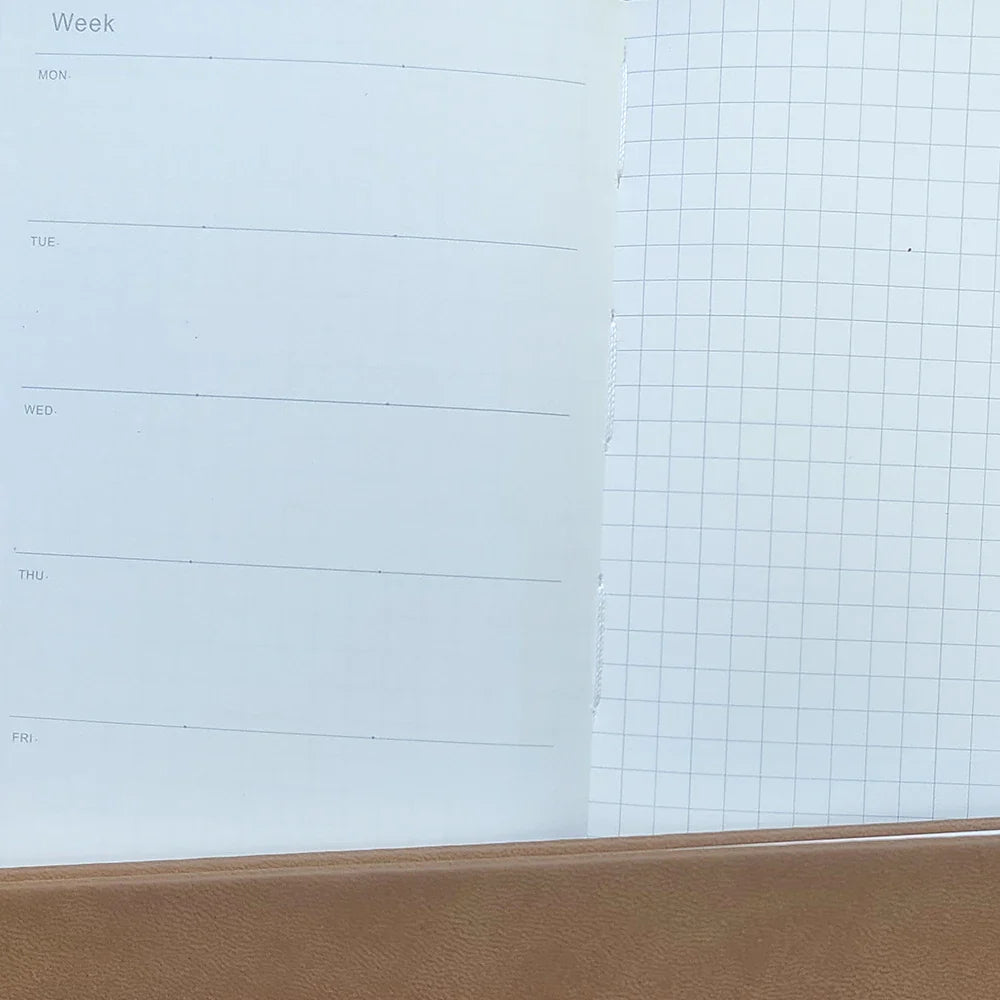 Slim weekly planner notebook with ribbon markers and protective cover