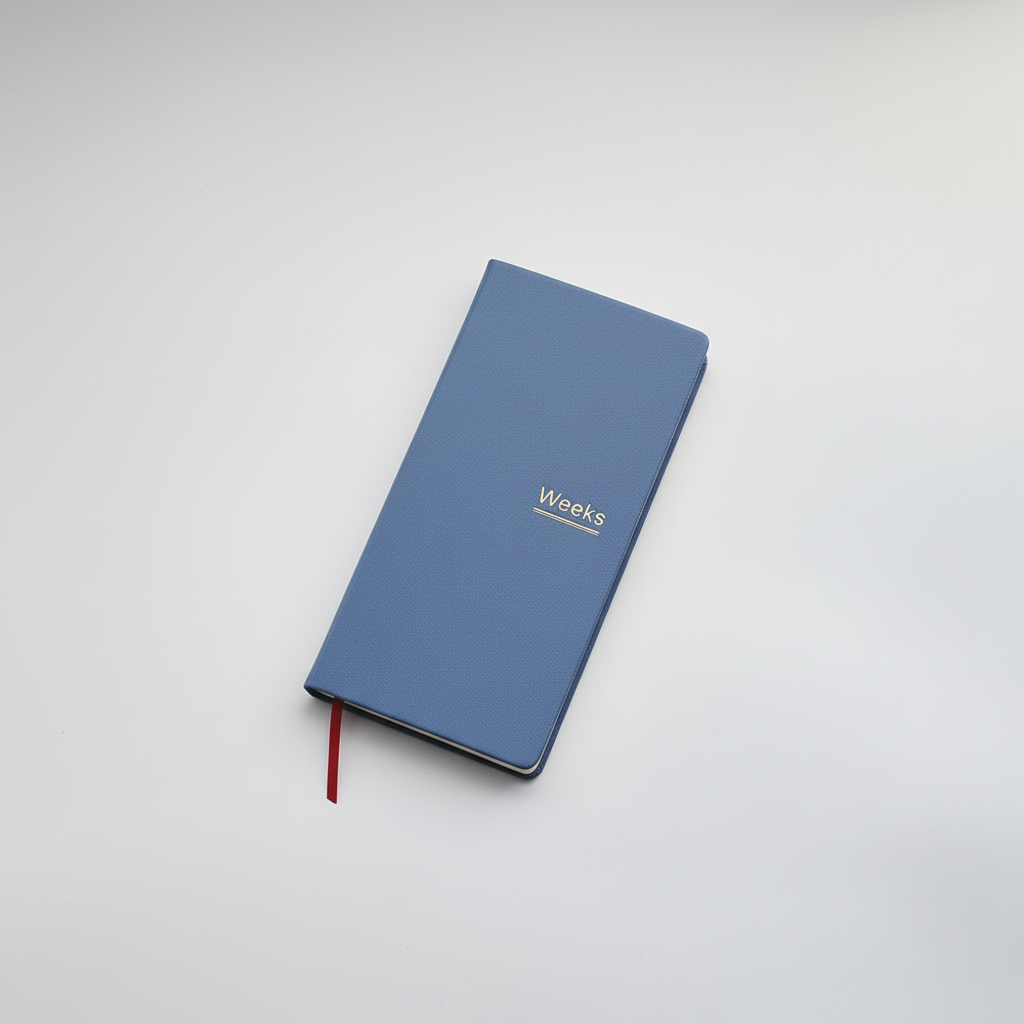 Slim weekly planner notebook with ribbon markers and protective cover